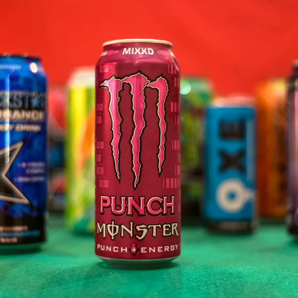 A can of Monster Punch in front of a row of other energy drink cans