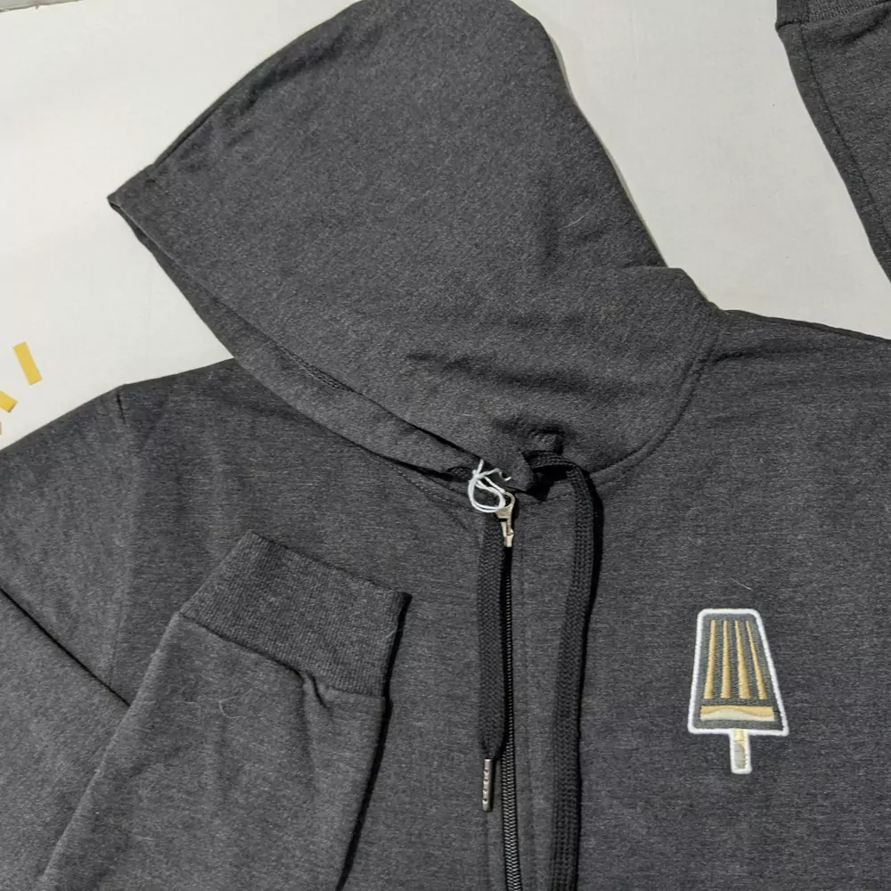 A charcoal zip up hoodie laid flat
