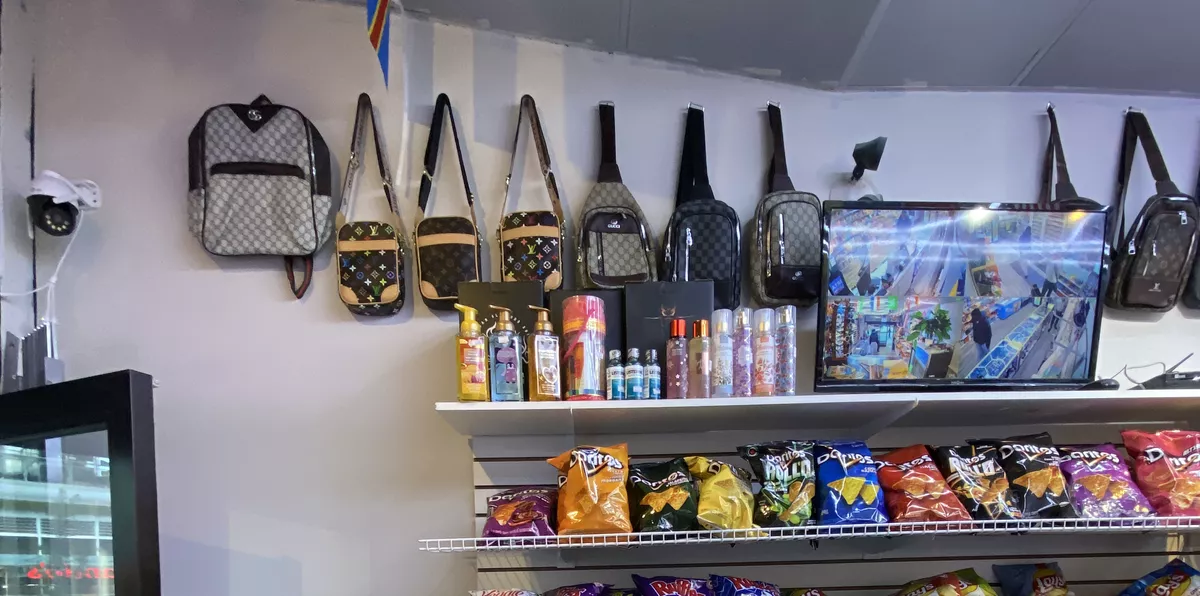 Bags hanging along the wall above the shelves